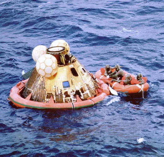 Columbia floats on the ocean as Navy divers assist in retrieving the astronauts - image