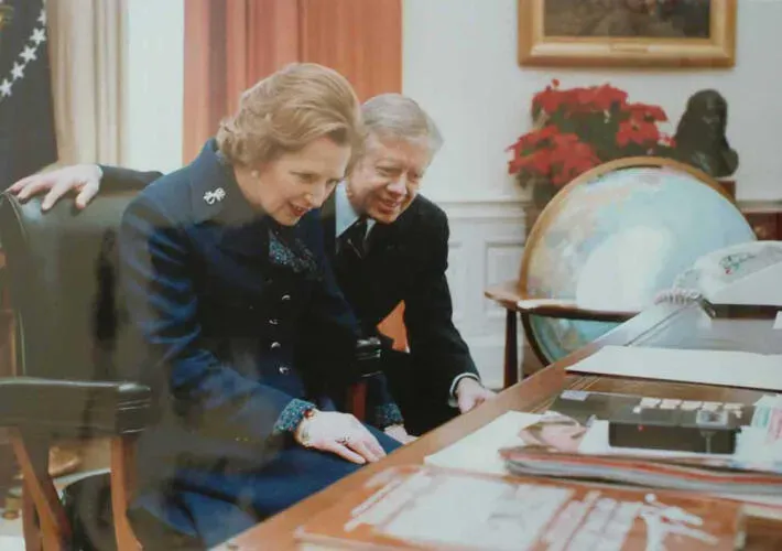 Margaret Thatcher with Jimmy Carter looking at the president's desk, the Resolute Desk