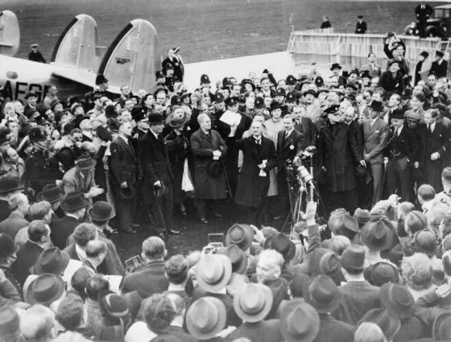 Munich Agreement - British Prime Minister Neville Chamberlain after landing at Heston Aerodrome following his meeting with Adolf Hitler