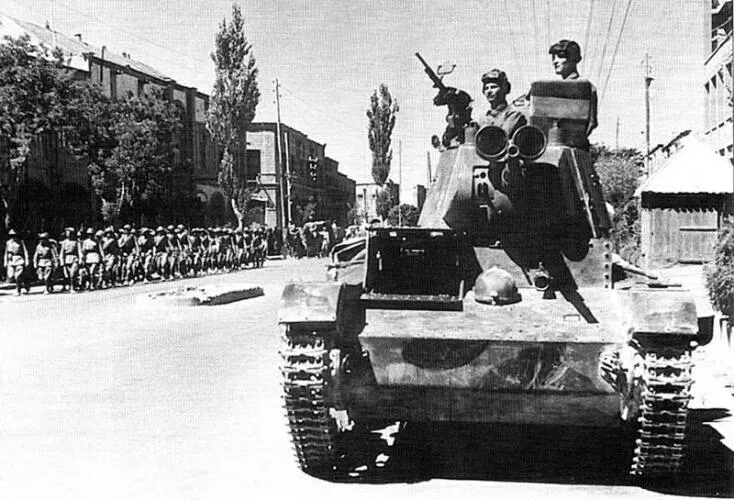 Soviet tankmen of the 6th Tank Division drive through the streets of Tabriz on their T-26 light tank