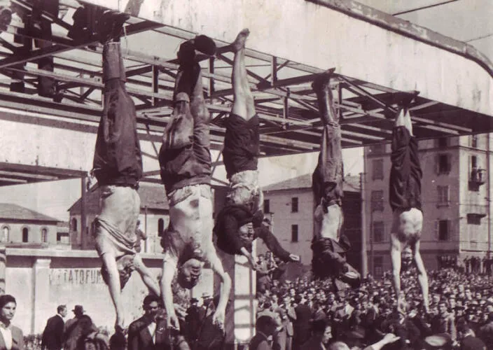 The corpse of Mussolini (second from left) next to Petacci (middle) and other executed fascists in Piazzale Loreto, Milan, 1945