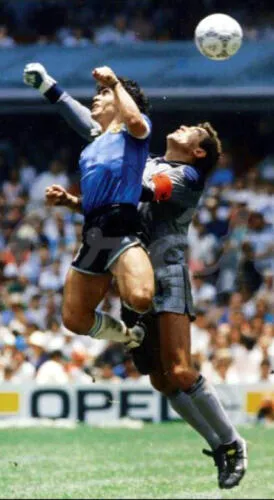 The moment when Diego Maradona flicks the ball with the hand past the outstretched arm of Peter Shilton