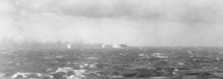 The sinking German battleship Bismarck on fire in the distance, surrounded by shell splashes