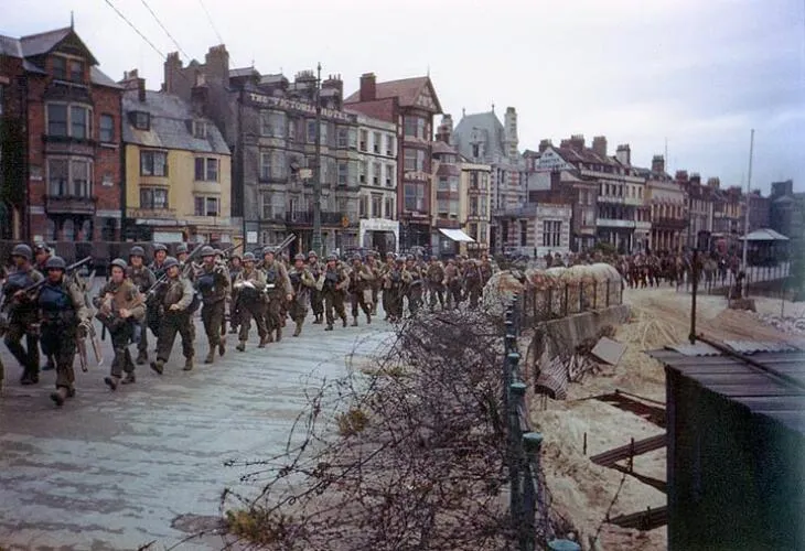 U.S. soldiers march through Weymouth, Dorset, en route to board landing ships for the invasion of France