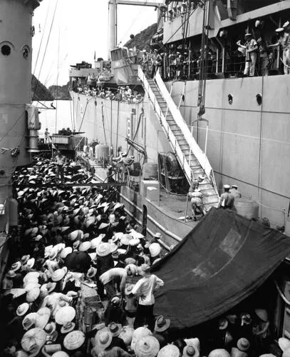 Vietnamese refugees move from a French landing ship to the USS Montague during Operation Passage to Freedom - image