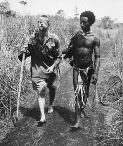 Wounded Australian soldier led by a Papuan orderly at Buna