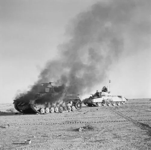 A Crusader Mk.1 passes a burning German Panzer IV - Operation Crusader