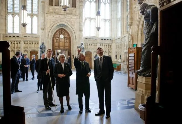 US President Barack Obama (right) in the Members' Lobby during a tour of the Palace in May 2011. With him are, from the left: the Lord Great Chamberlain, the Marquess of Cholmondeley, holding his white staff of office; the Lord Speaker, Baroness Hayman; and the Speaker of the House of Commons, John Bercow