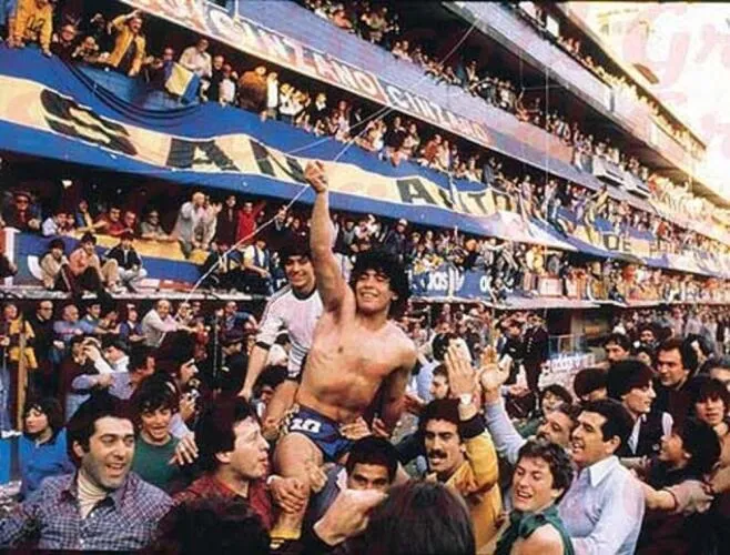 Maradona being held aloft by fans of Boca Juniors after winning the 1981 Metropolitano championship