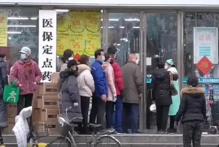 Citizens of Wuhan lining up outside of a drug store to buy masks during the Wuhan coronavirus outbreak Image
