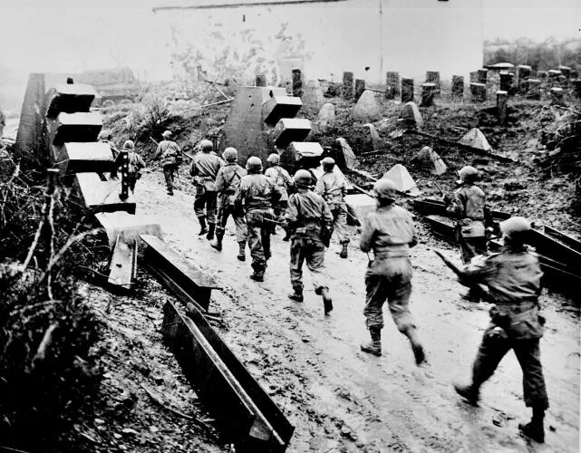 U.S. Army troops cross the Siegfried Line